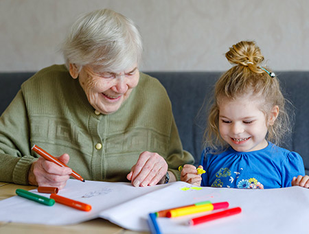 elderly woman and child drawing