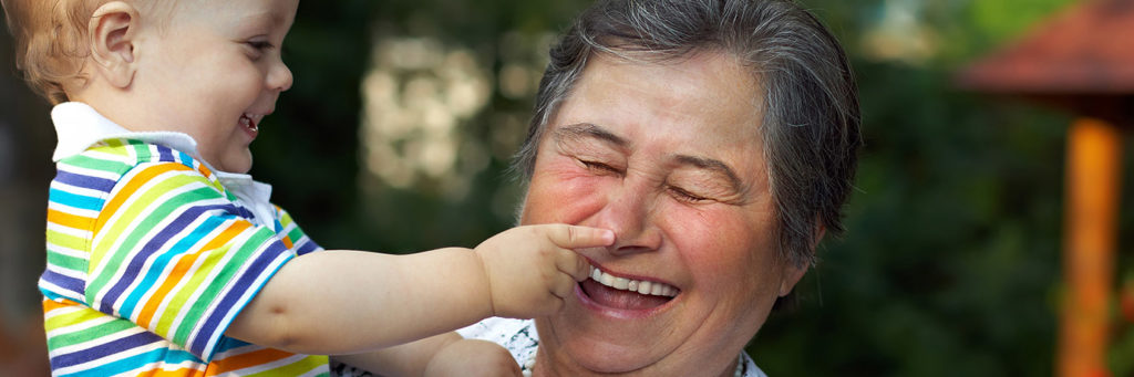 baby touching grandma's nose