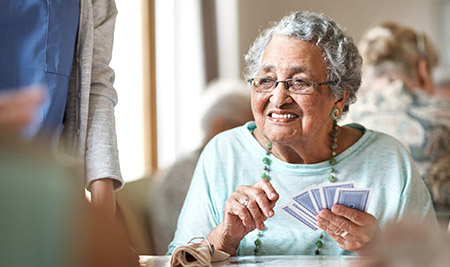 elderly woman playing cards